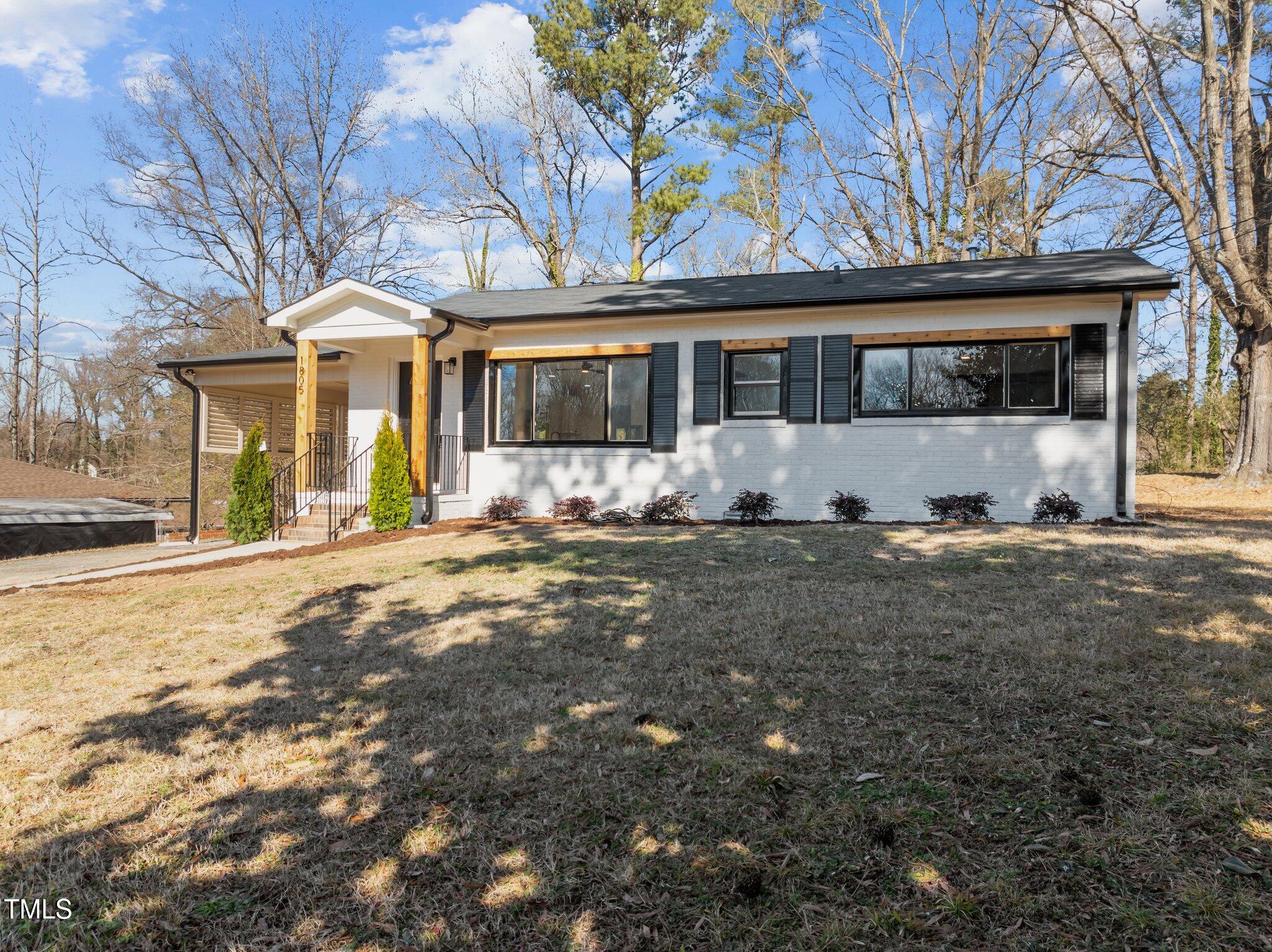 1805 Pritchard Place Durham, NC 27707 - Photo 4 of 46 a front view of a house with a yard covered in snow