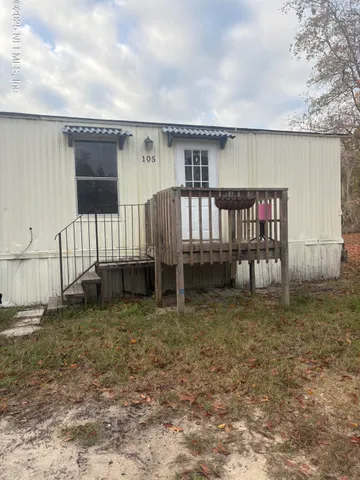 a backyard of a house with wooden deck