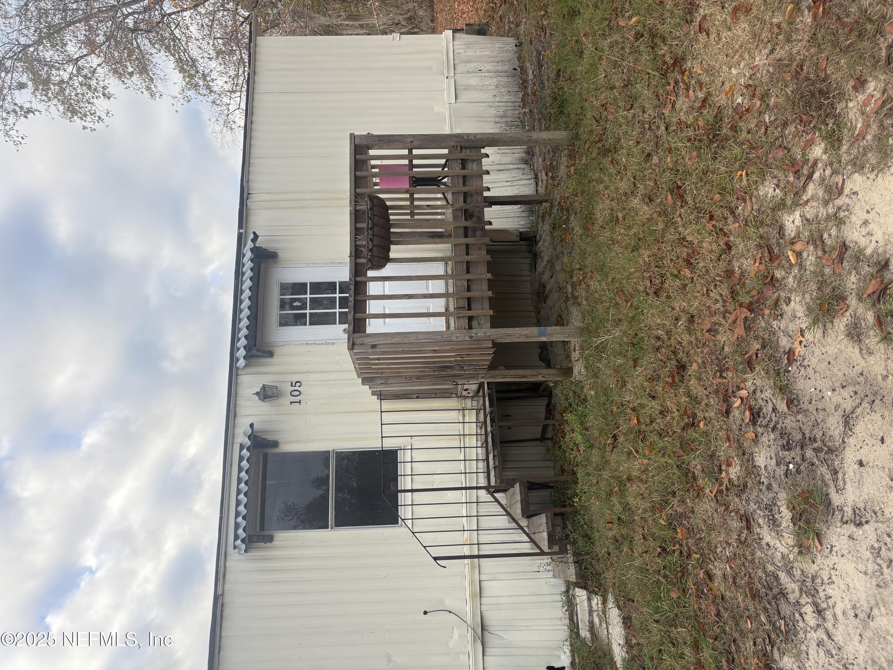 a backyard of a house with wooden deck