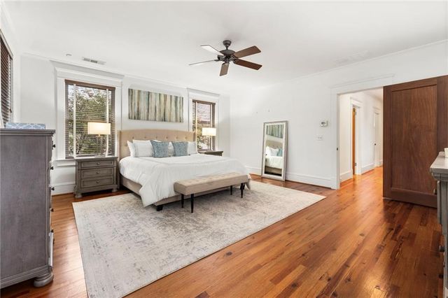 a spacious bedroom with a bed and a chandelier