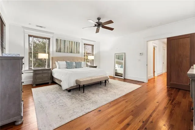 a spacious bedroom with a bed and a chandelier