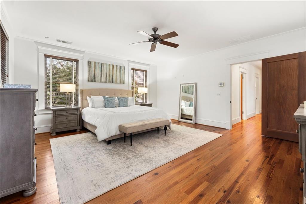 121 17th Street Northeast Atlanta, GA 30309 - Photo 27 of 53 a spacious bedroom with a bed and a chandelier