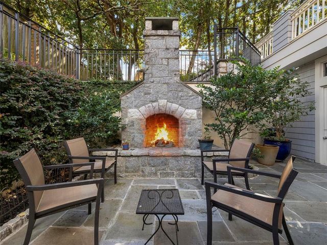 a view of a patio with table and chairs with wooden floor and fence