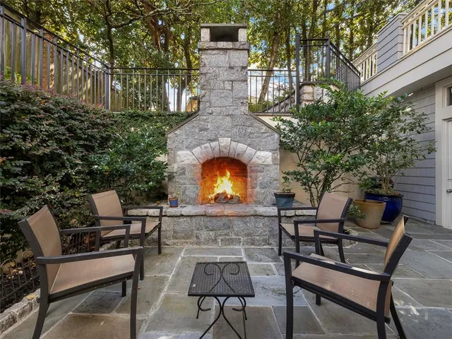 a view of a patio with table and chairs with wooden floor and fence