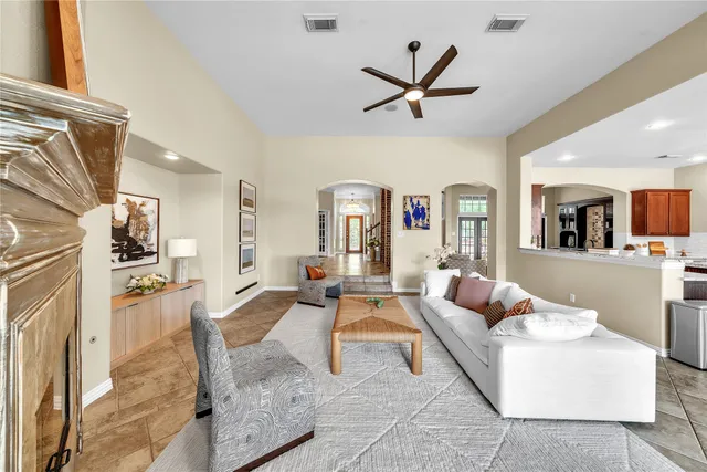 a living room with furniture a fireplace and a window