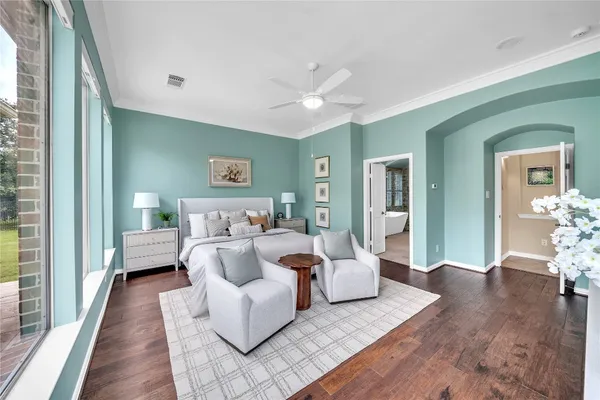 a bedroom with furniture and wooden floor
