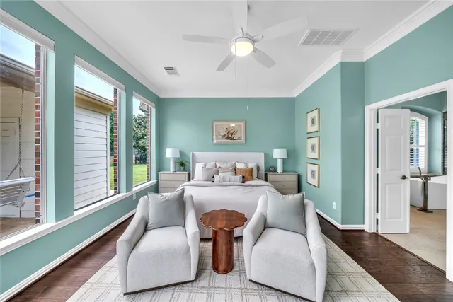 a spacious en suite bathroom with double vanity and a large mirror