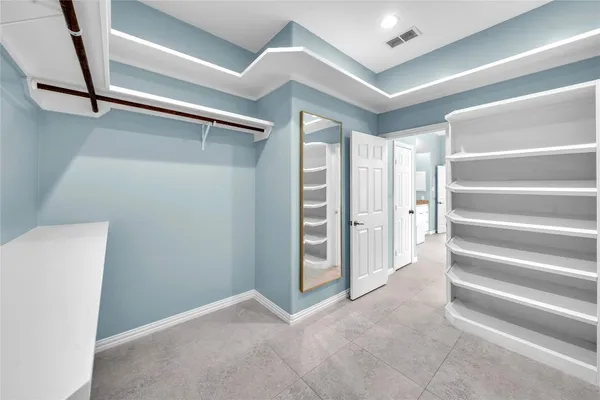 a view of an empty room with a staircase