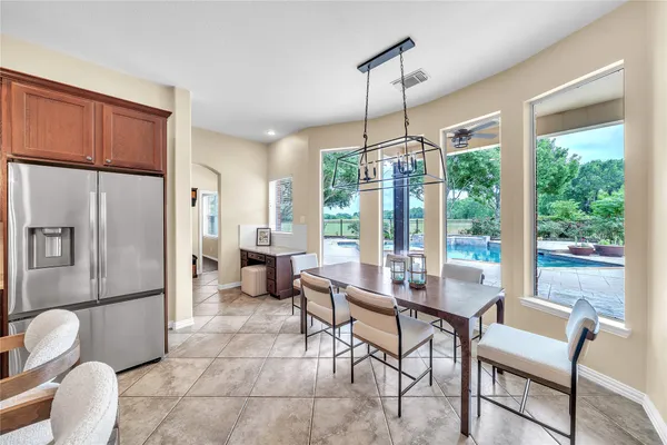 a dining room with furniture a chandelier and wooden floor