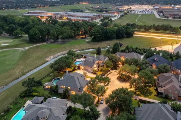 an aerial view of residential houses with outdoor space and river