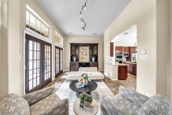 a living room with furniture fireplace and a large window