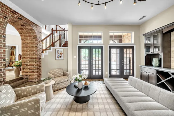 a living room with furniture and a potted plant