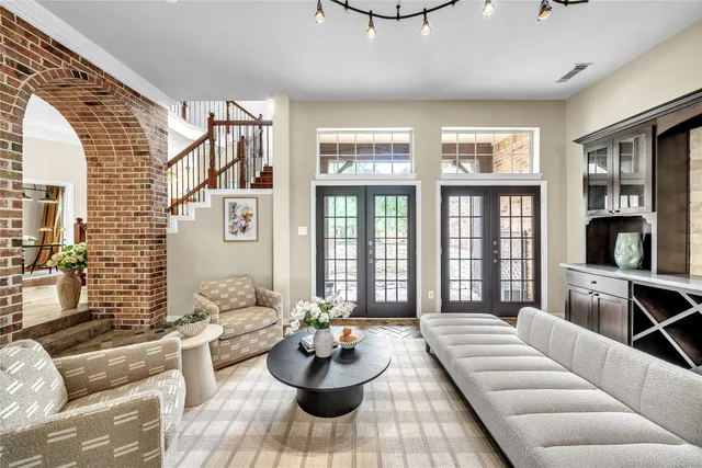 a large kitchen with kitchen island a large counter top stainless steel appliances and cabinets