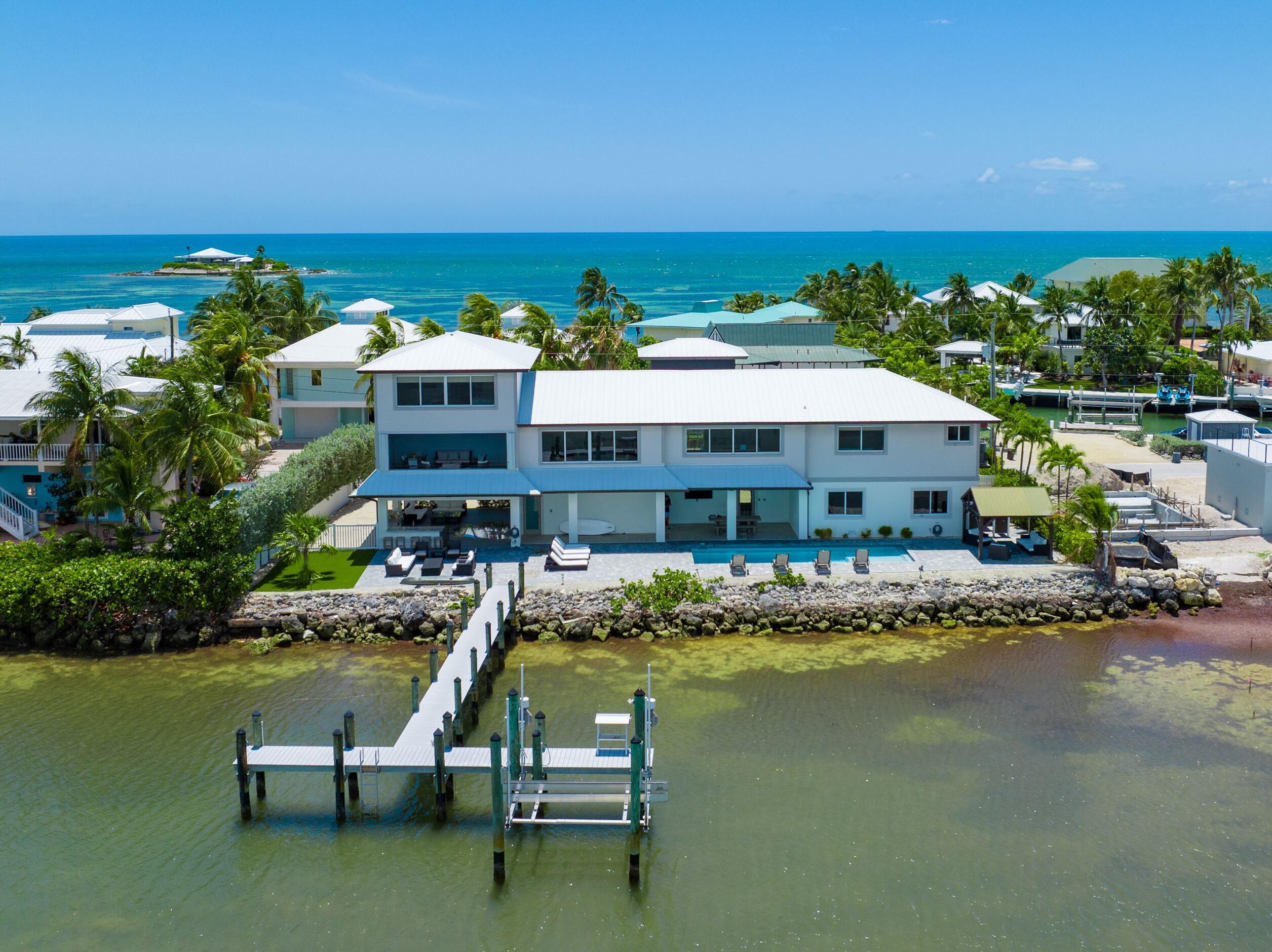 a view of a house with swimming pool and sitting area