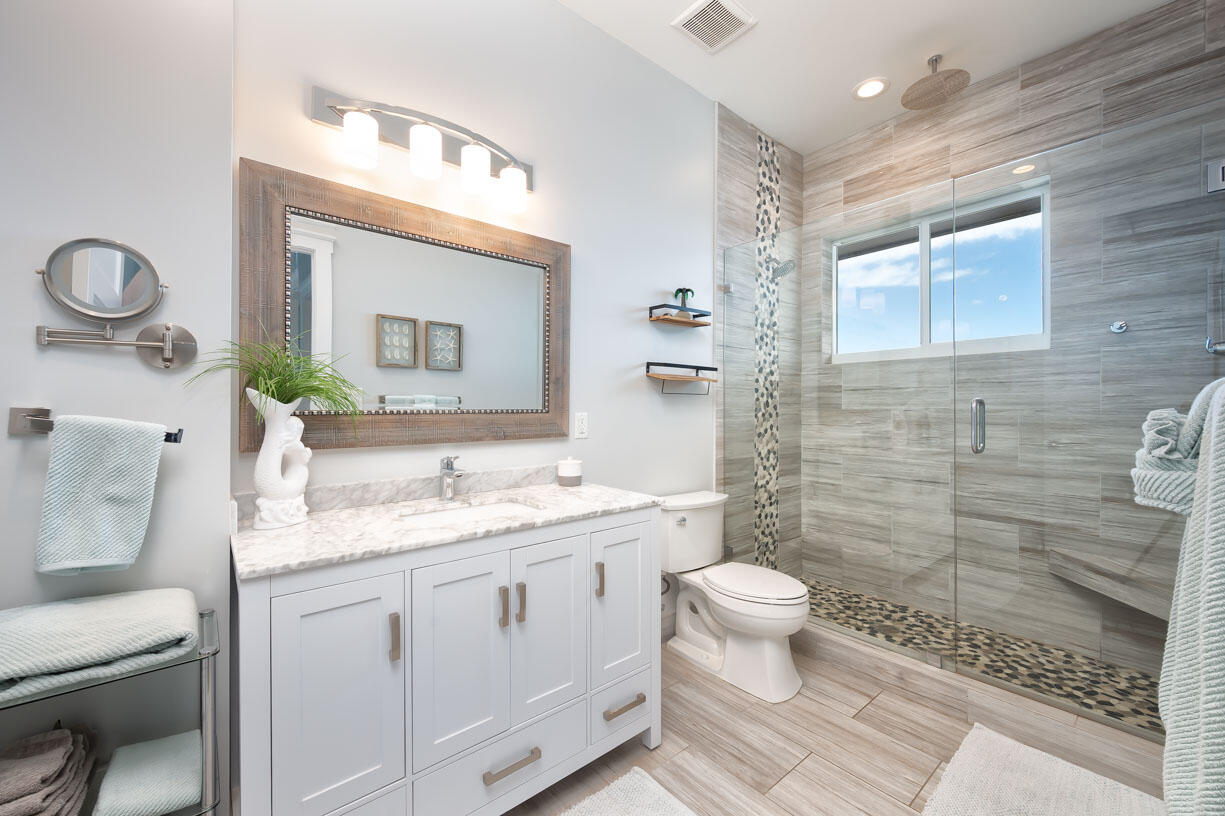 14 East Ocean Drive Marathon, FL 33050 - Photo 17 of 48 a bathroom with a granite countertop sink mirror vanity and toilet