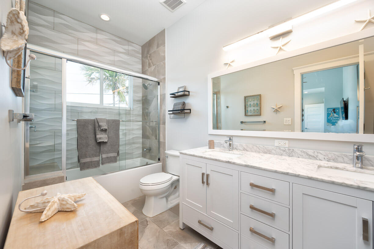 14 East Ocean Drive Marathon, FL 33050 - Photo 19 of 48 a spacious bathroom with a granite countertop sink toilet and shower
