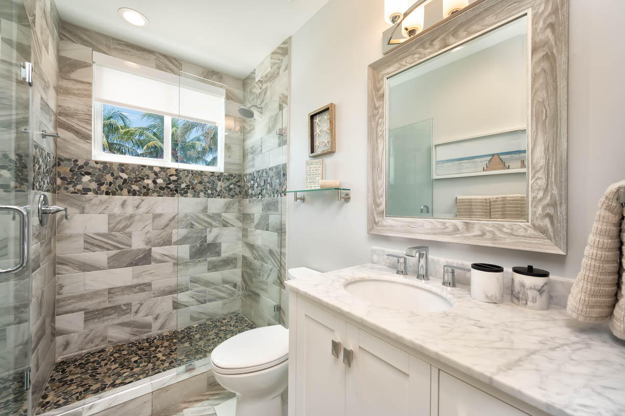 14 East Ocean Drive Marathon, FL 33050 - Photo 21 of 48 a bathroom with a granite countertop sink toilet and mirror