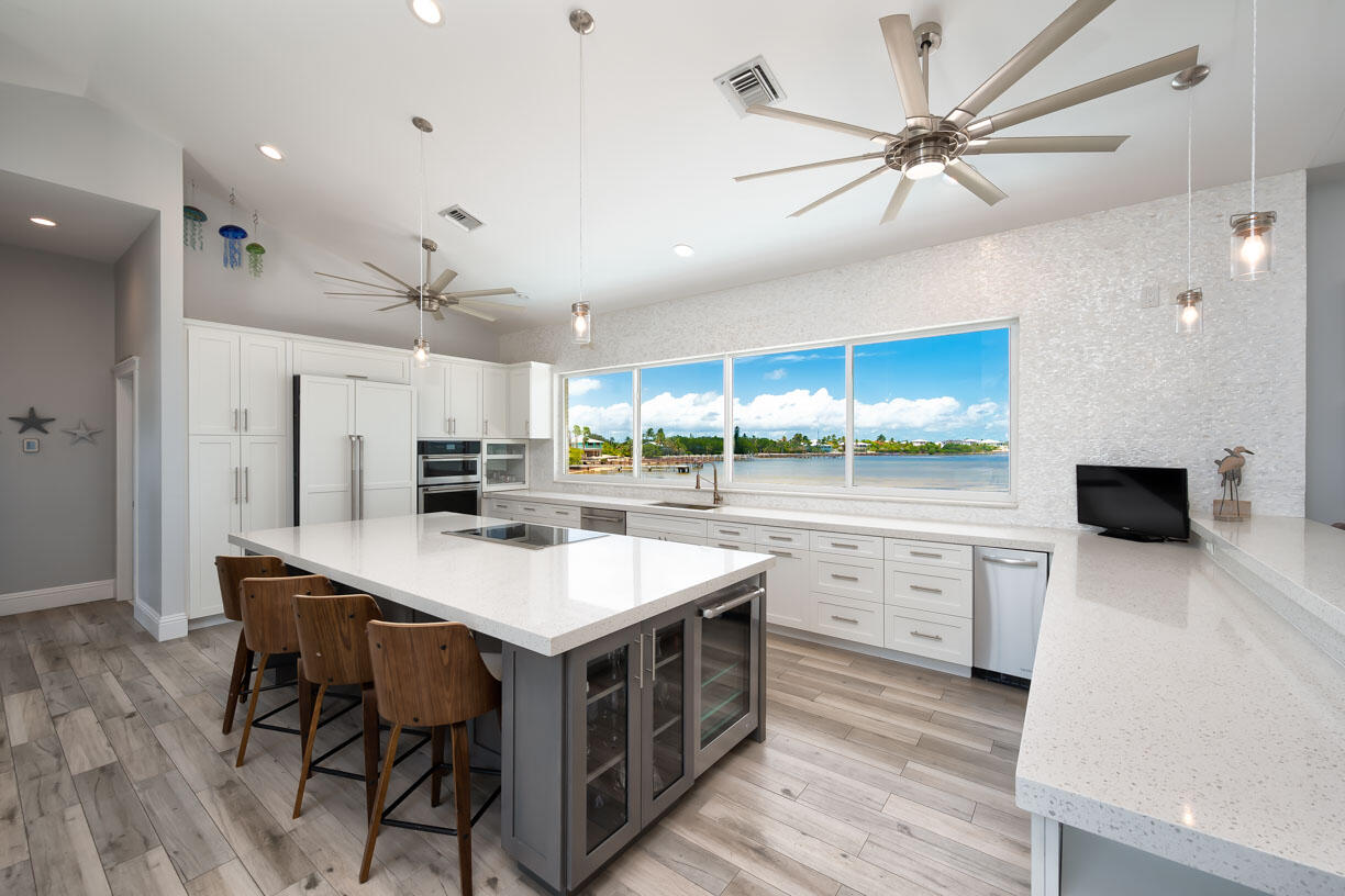 14 East Ocean Drive Marathon, FL 33050 - Photo 8 of 48 a kitchen with a table chairs microwave and cabinets