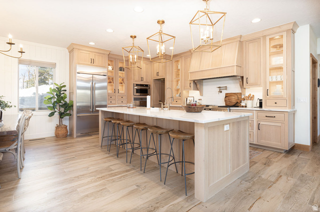 382 Ridgeview Street, Unit 8 & 9 Brian Head, UT 84719 - Photo 10 of 52 Spacious kitchen featuring light wood cabinetry, a large center island with a stone countertop, stainless steel appliances, and integrated range hood