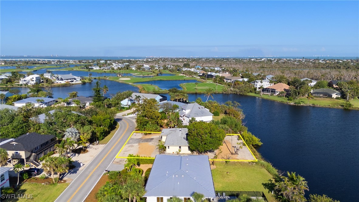1457 Sand Castle Road Sanibel, FL 33957 - Photo 4 of 41 an aerial view of a house with a swimming pool outdoor seating and yard