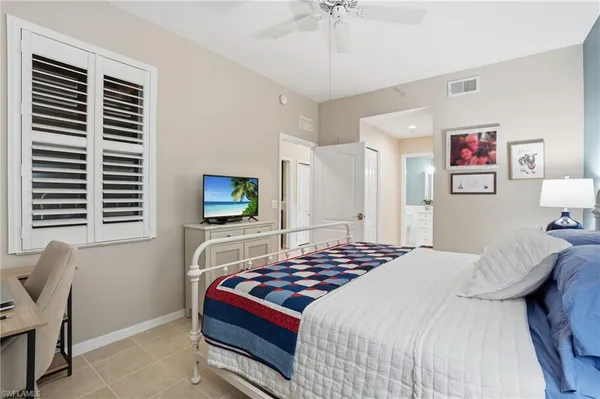 a bedroom with two beds and a chandelier