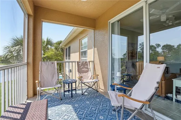 a view of a balcony with chair and wooden floor