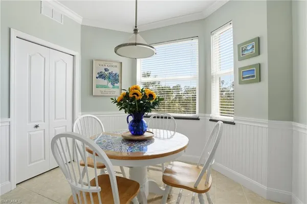 a living room with furniture and a view of kitchen