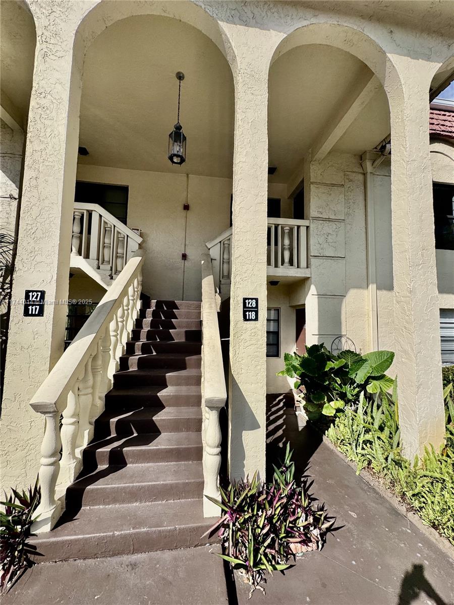 140 South Cypress Road, Unit 128 Pompano Beach, FL 33060 - Photo 5 of 13 a view of entryway and hall with wooden floor