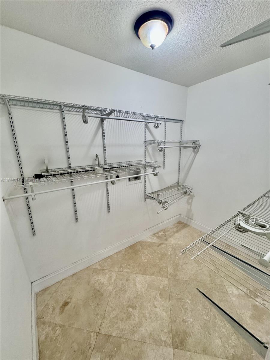 140 South Cypress Road, Unit 128 Pompano Beach, FL 33060 - Photo 8 of 13 a view of a room with racks on the wall