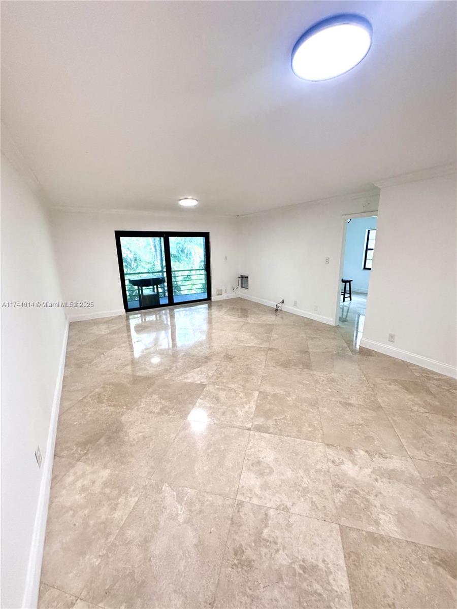 140 South Cypress Road, Unit 128 Pompano Beach, FL 33060 - Photo 9 of 13 a view of an empty room with a window