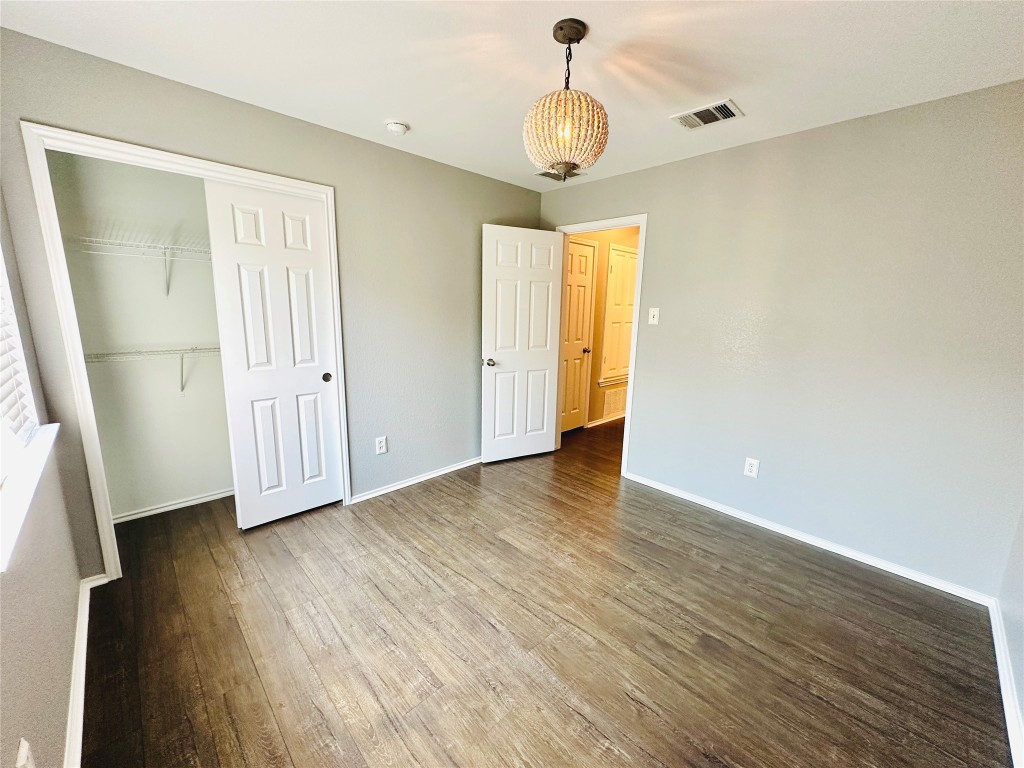 12112 Rancho Alto Road Austin, TX 78748 - Photo 12 of 34 a view of empty room with wooden floor and fan