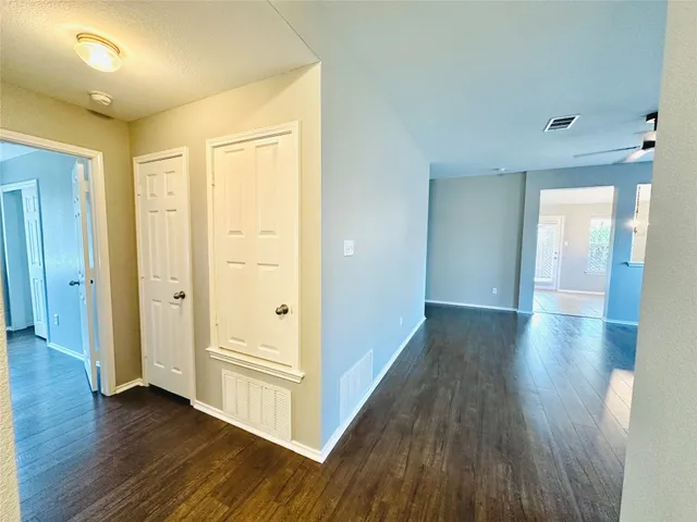 a view of a hallway with wooden floor