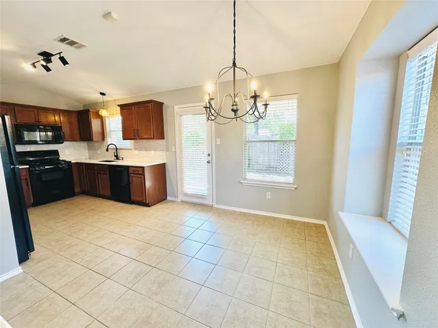 a view of kitchen with window and refrigerator