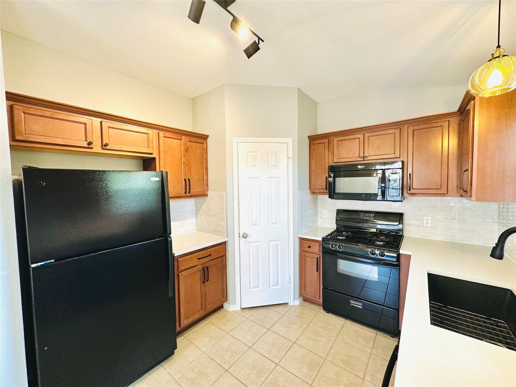 12112 Rancho Alto Road Austin, TX 78748 - Photo 21 of 34 a kitchen with stainless steel appliances granite countertop a refrigerator and a stove top oven