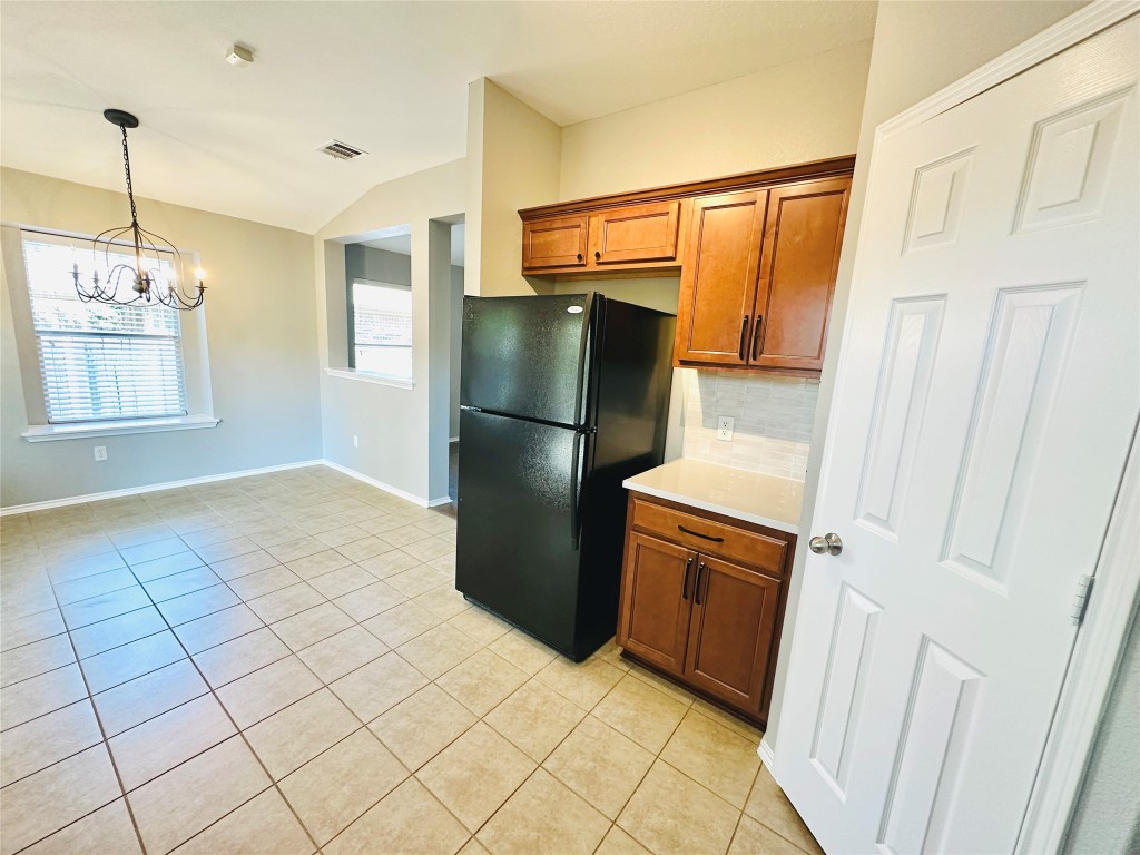 12112 Rancho Alto Road Austin, TX 78748 - Photo 22 of 34 a kitchen with stainless steel appliances a refrigerator and a stove top oven