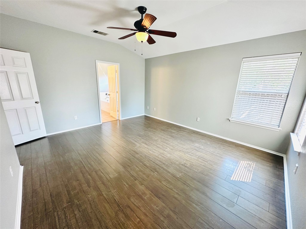 12112 Rancho Alto Road Austin, TX 78748 - Photo 26 of 34 an empty room with wooden floor and windows