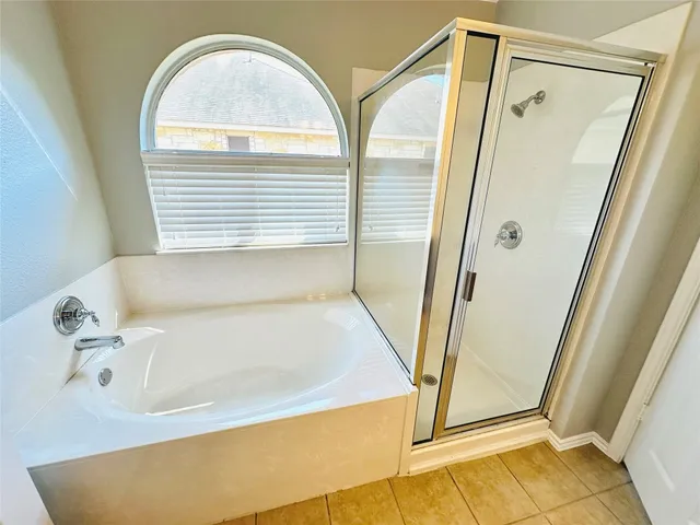 a bathroom with a tub and a shower