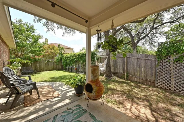 a view of a porch with chairs and backyard