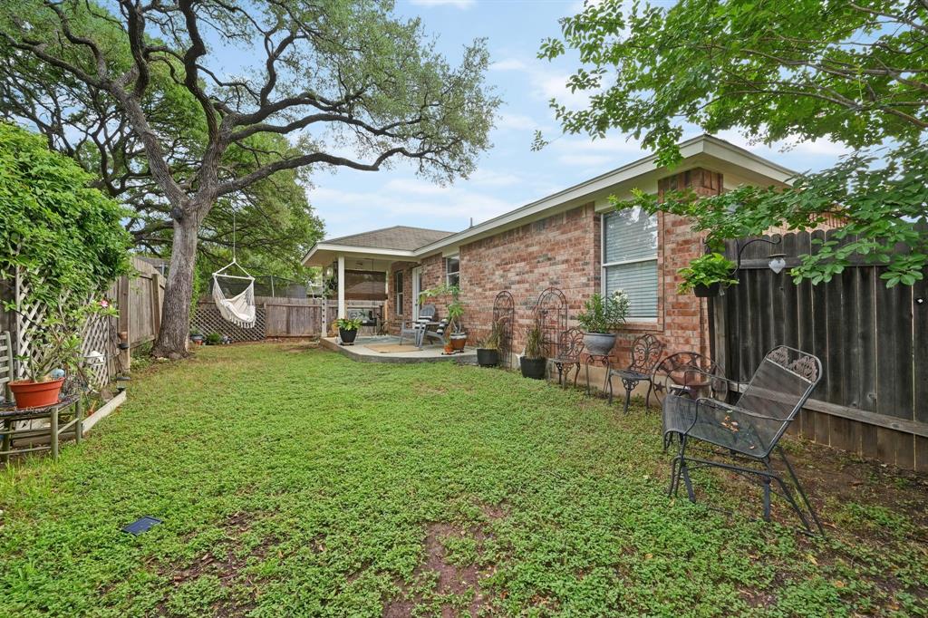 12112 Rancho Alto Road Austin, TX 78748 - Photo 34 of 34 a view of a chair and table in backyard of the house