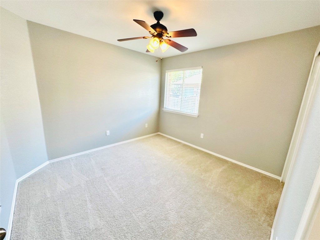 12112 Rancho Alto Road Austin, TX 78748 - Photo 8 of 34 an empty room with a window and a fan