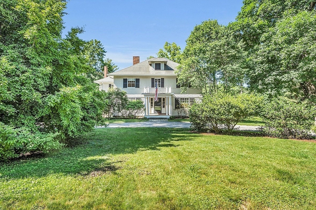 24 Sandy Pond Road Lincoln, MA 01773 - Photo 1 of 42 a front view of a house with a yard
