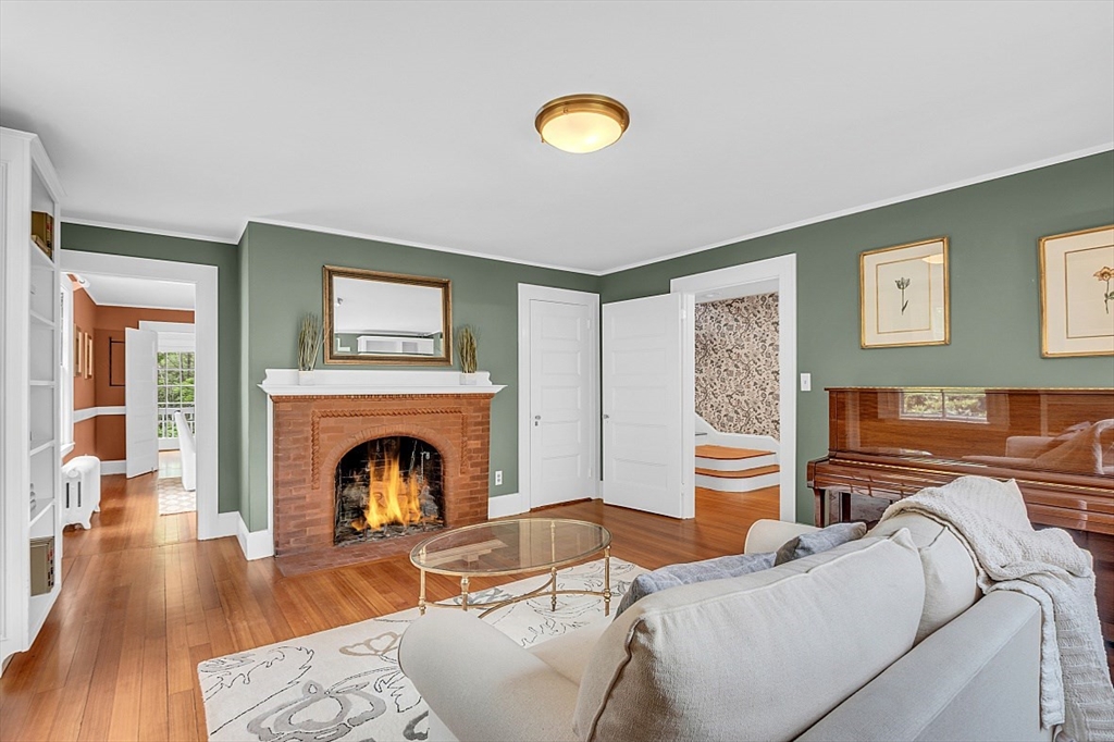 24 Sandy Pond Road Lincoln, MA 01773 - Photo 11 of 42 a living room with furniture and a fireplace