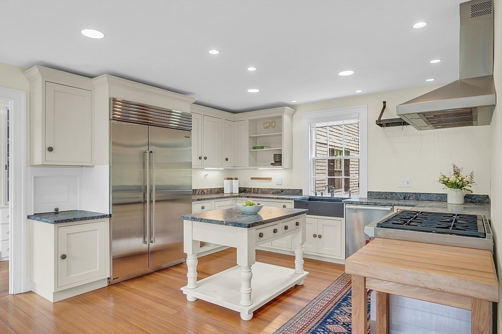 24 Sandy Pond Road Lincoln, MA 01773 - Photo 18 of 42 a kitchen with granite countertop a stove a sink and a refrigerator