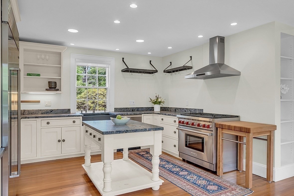 24 Sandy Pond Road Lincoln, MA 01773 - Photo 19 of 42 a kitchen with a stove top oven sink and cabinets