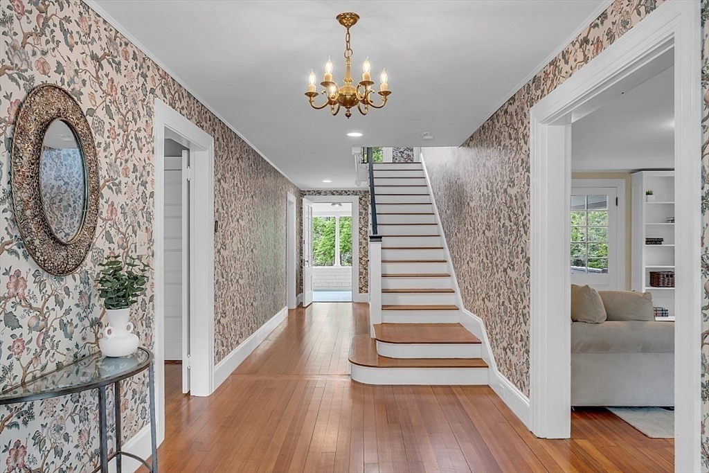 24 Sandy Pond Road Lincoln, MA 01773 - Photo 22 of 42 a view of a hallway with wooden floor and staircase