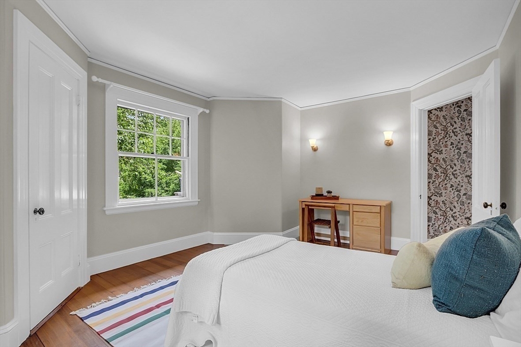 24 Sandy Pond Road Lincoln, MA 01773 - Photo 29 of 42 a bedroom with a bed and a chair