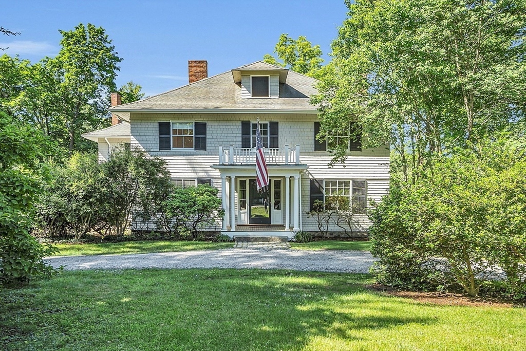 24 Sandy Pond Road Lincoln, MA 01773 - Photo 3 of 42 a front view of a house with a garden