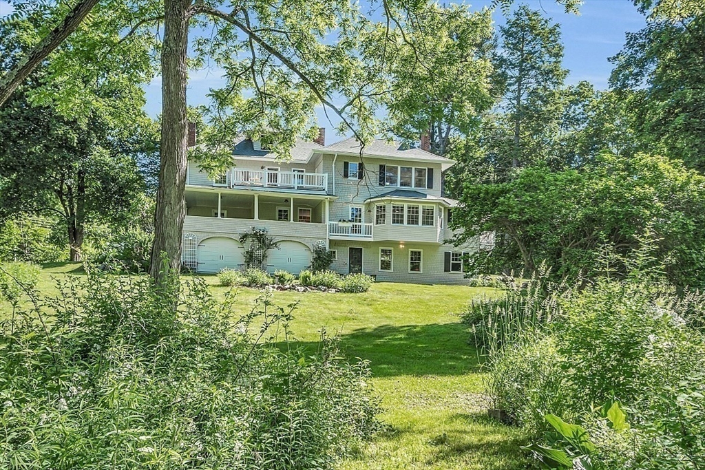 24 Sandy Pond Road Lincoln, MA 01773 - Photo 34 of 42 a front view of a house with a yard