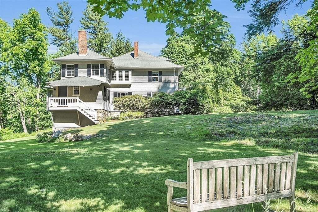 24 Sandy Pond Road Lincoln, MA 01773 - Photo 37 of 42 a front view of a house with a yard