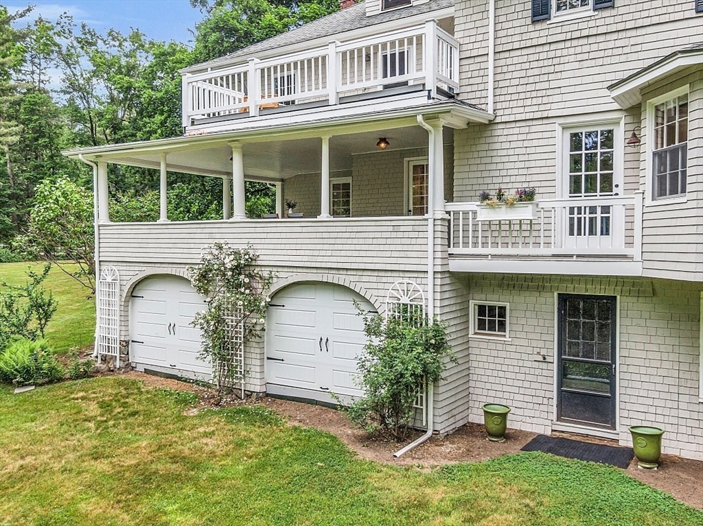 24 Sandy Pond Road Lincoln, MA 01773 - Photo 41 of 42 a front view of a house with a yard